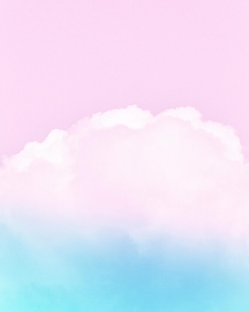 Soft pastel clouds against a pink and blue sky, perfect for serene backgrounds.